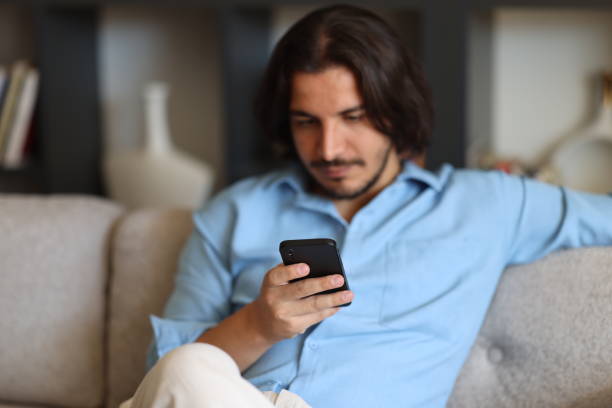 istock Portrait of cheerful man using smartphone to read messages or scroll through social networks, daily routine 2176974829