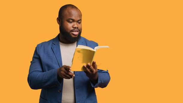 istock Person presenting literature novel, reciting from pages, studio background 2176978160