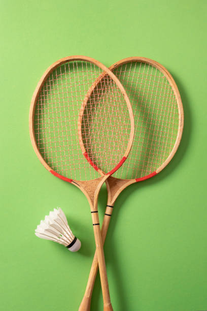 istock White badminton shuttlecocks and two badminton rackets. Concept racket sport. 2176981369