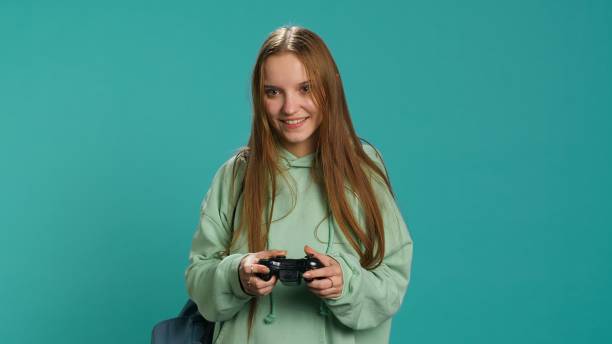 istock Young gamer girl holding controller, focused on finishing game 2176985344