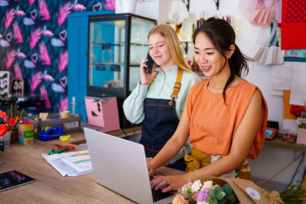 istock Two florists working together in flower shop 2176992328