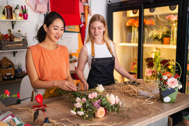 istock Flower Shop Workers Decorating A Bouquet Together 2176992514