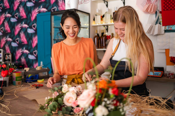istock Flower Shop Workers Decorating A Bouquet Together 2176992540