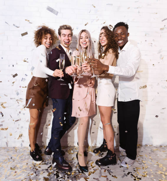 istock Diverse Colleagues Clinking Glasses Partying Under Falling Confetti Indoor, Full-Length 2176992659
