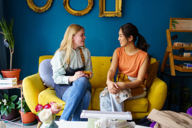 istock Two women having a talk while taking a break from work at flower shop 2176993457
