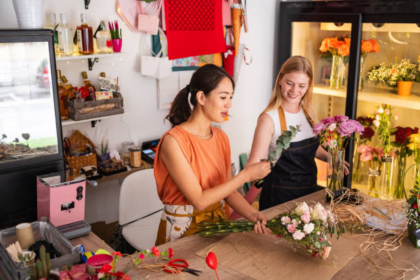 istock Florists Arranging A Bouquet Together In Flower Shop 2176993600