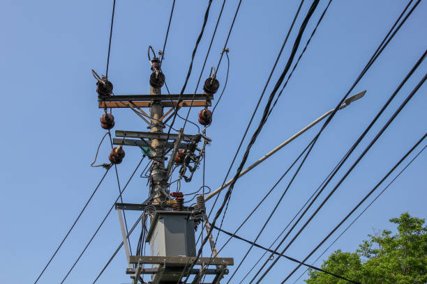 istock Electric poles with many cables and small transformers installed with a blue sky background 2176994011