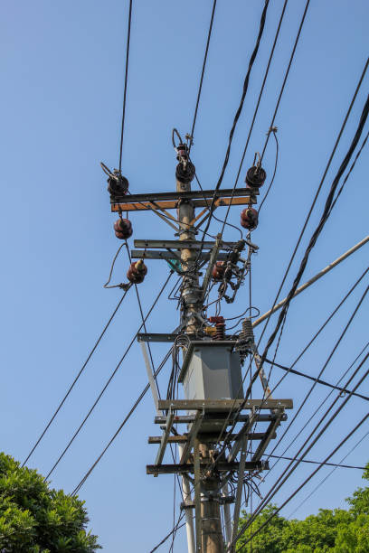 istock Electric poles with many cables and small transformers installed with a blue sky background 2176994019