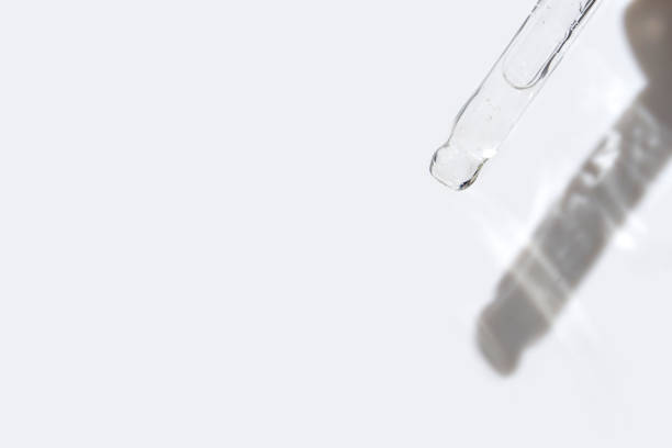 istock Minimalist skincare concept with glass dropper casting shadow on white 2176995608