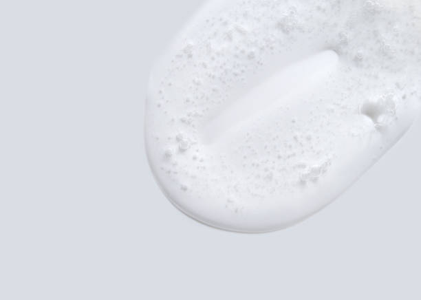 istock Smooth white creamy liquid with bubbles on gray background texture and skincare 2176995622