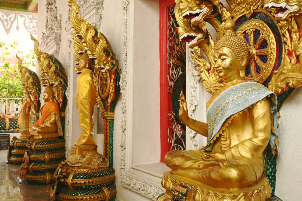istock A group of Buddha statues in various postures with a serpent covering the top. Decorated around the chapel at Wat Naga Prok Temple. 2176999878