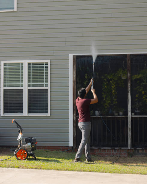 istock Man Pressure Washing Vinyl Siding - House 2177004682