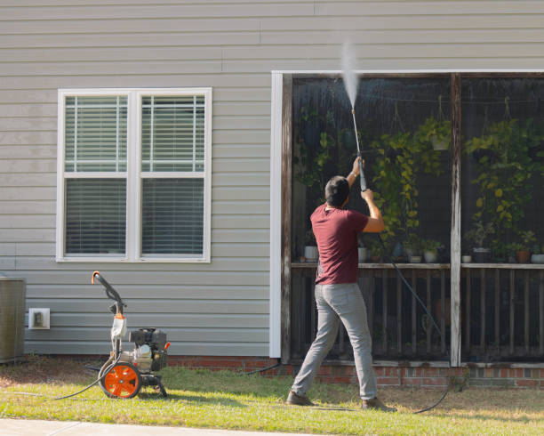 istock Man Pressure Washing Vinyl Siding - House 2177004729