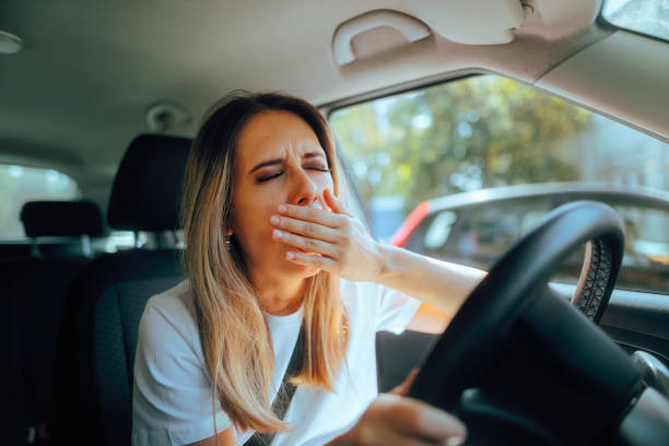 istock Fatigued Driver Yawning Feeling Sleepy Behind the Wheel 2177016767