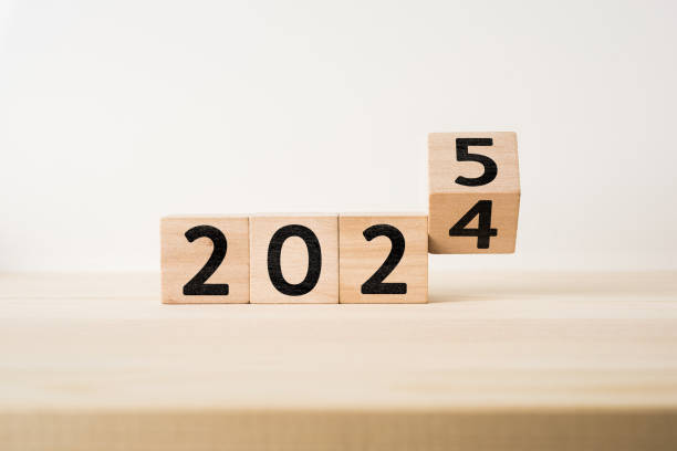 istock floating fly wooden cube with word 2025 and 2024 2177018249