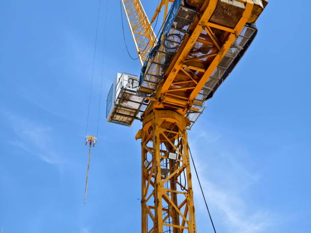 istock A large yellow crane stands out against a bright blue sky 2177020927