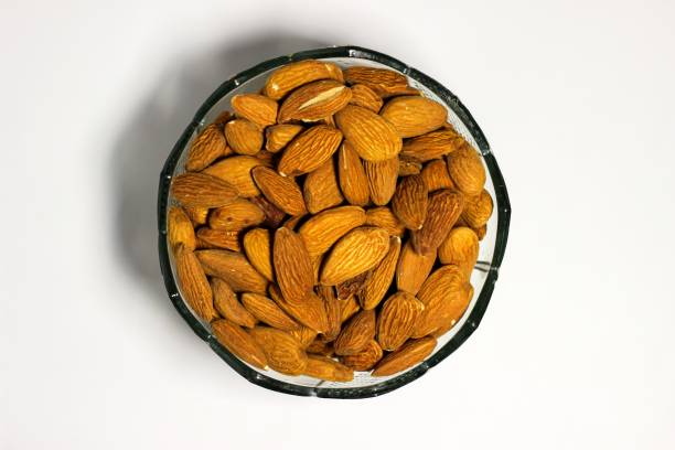 istock Almonds nut, walnuts, cashew and hazelnuts in glass bowls 2177023424