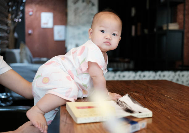 Eurasian preschool age girl reading a book at home on the floor. A cute little girl lying on her bed reading a book.