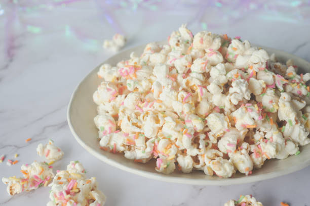 istock white chocolate colorful confetti popcorn in ceramic bowl. 2177031124