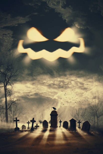 Creepy Jack-o'-lantern pumpkin face in the sky and old cemetery, Halloween and horror background