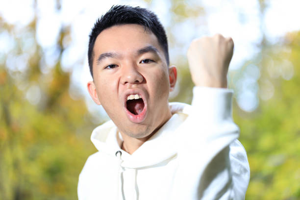istock A young man cheering with a fist pump 2177033305