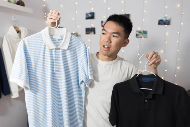 istock Young man deciding between what shirt to wear 2177033365