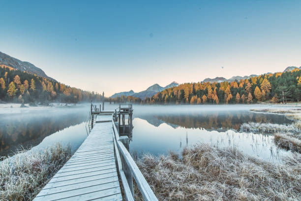 istock Alpine lake with autumn fogs 2177034732