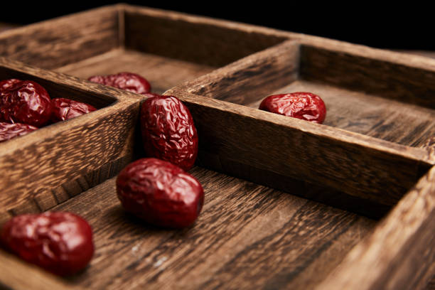 Red dates on wooden tabletop, indoor scene