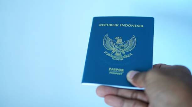 istock a man shows an Indonesian passport 2177040116