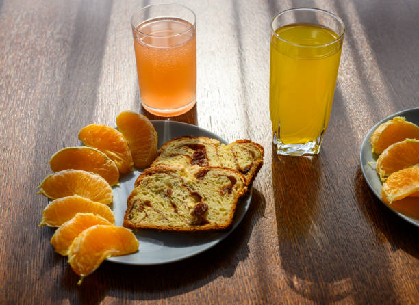 Orange breakfast, juice and pieces of fruit on a plate