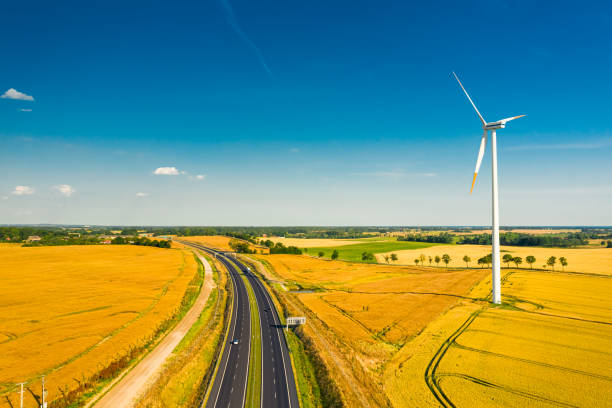 istock Wind turbines, highway and golden fields in summer, aerial view 2177042710