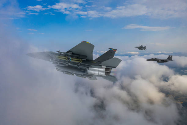 istock F-15 Eagle jet aircrafts flying over clouds. 2177043747