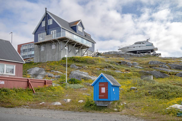 Nuuk, Godthåb, Greenland, Denmark - August 19th 2024:  Modern detached residential buildings with a small hut for installations in front