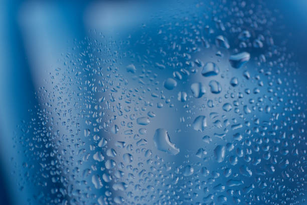Water droplets on glass with blue background