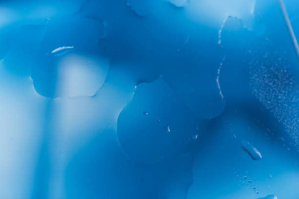 Water droplets on glass with blue background