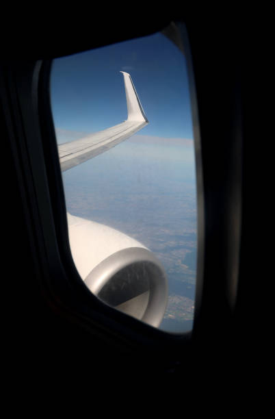 istock jet engine and wing seen through a commercial airline window during flight 2177051784