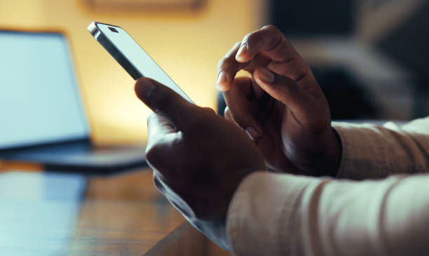 istock Businessman's Hands Texting on Mobile Phone Late at Night 2177052432