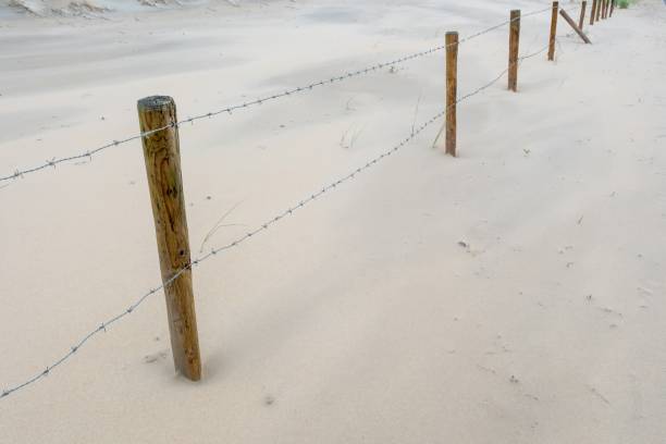barbed wire fence on the sandy beach