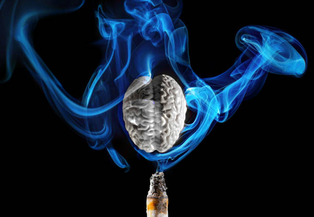istock Gray Brain Surrounded by Blue Smoke from Cigarette on Black Background 2177055987