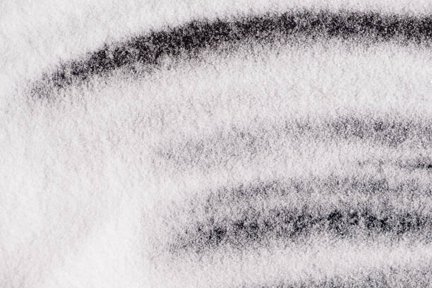 istock Finely ground stone white rock salt texture on black background, top view. 2177059254