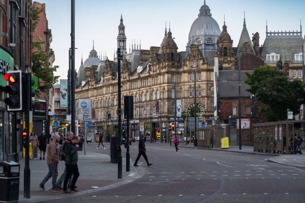 16.08.2024 Leeds, UK. Leeds city center showcases stunning historic architecture, blending the city's rich heritage with its modern hustle and bustle. Pedestrians navigate the streets, surrounded by grand, ornate buildings.