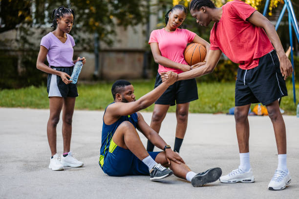istock Young Black Man Helping A Teammate Stand Up While Playing Basketball 2177063042