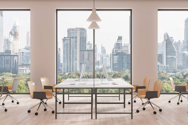 istock Office coworking interior with pc monitors in row, panoramic window 2177065575