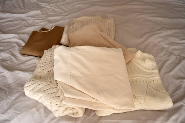 istock Stack of Neutral Knit Sweaters and Clothing Fabrics 2177066579