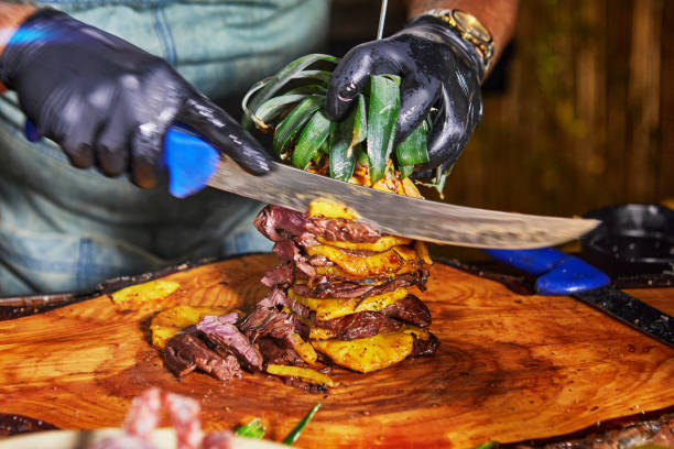 istock Chef Carving Grilled Meat with Pineapple 2177068629