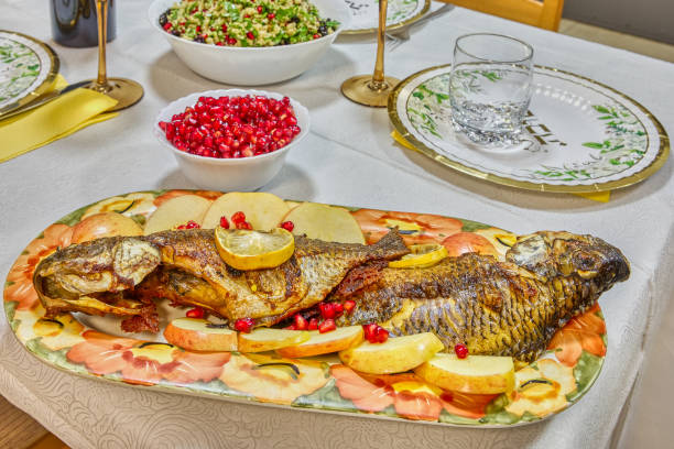 istock A beautifully roasted whole fish presented on a floral platter, garnished with fresh lemon slices and pomegranate seeds 2177068815