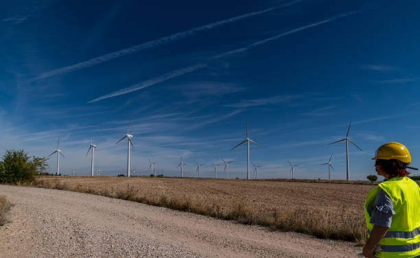 istock Wind turbine inspector working at a wind farm with scattered clouds.2 2177068868
