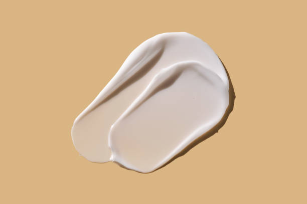 istock A smear of white cream on a beige background. 2177069423