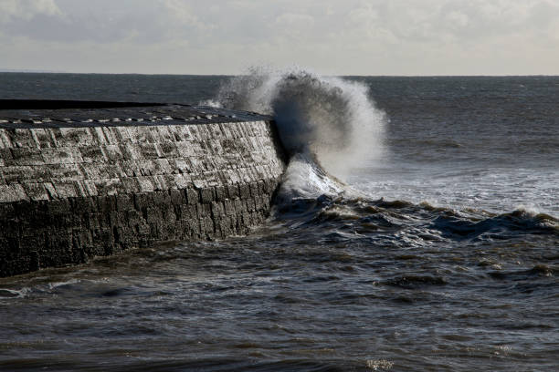 Waves crashing against the wall of the Cobb, Lyme Regis, Dorset, UK