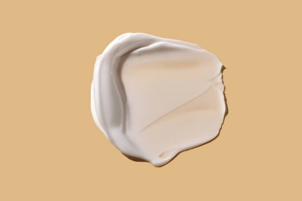 istock A smear of white cream on a beige background. 2177070407